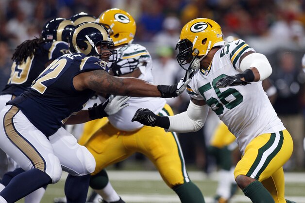 Green Bay Packers defensive end Julius Peppers, right, tries to get around St. Louis Rams offensive tackle Joe Barksdale during the first quarter of an NFL preseason football game Saturday, Aug. 16, 2014, in St. Louis. (AP Photo/Scott Kane)