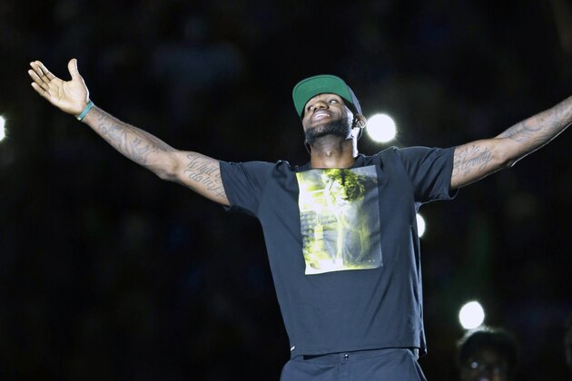Cleveland Cavaliers' LeBron James smiles as he is introduced at his homecoming at InfoCision Stadium Friday, Aug. 8, 2014, in Akron, Ohio. (AP Photo/Tony Dejak)