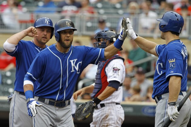 Kansas City Royals' Alex Gordon, front center, is congratulated by Billy Butler, left, and Josh Willingham, right, after his two-run home run off Minnesota Twins relief pitcher Caleb Thielbar during the fifth inning of a baseball game in Minneapolis, Sunday, Aug. 17, 2014. The Royals won 12-6. (AP Photo/Ann Heisenfelt)