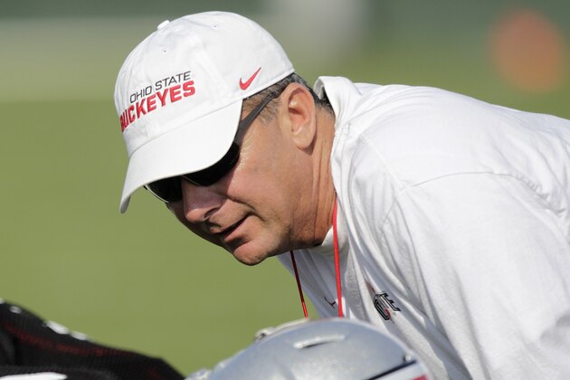 Ohio State head coach Urban Meyer talks with a player during an NCAA college football practice on Saturday, Aug. 9, 2014, in Columbus, Ohio. (AP Photo/Jay LaPrete)