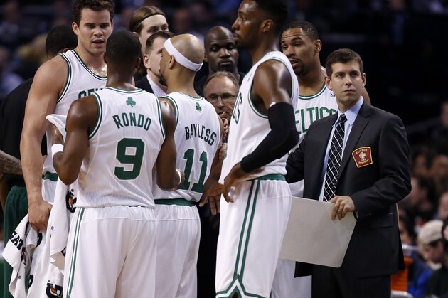 Boston Celtics head coach Brad Stevens, right, with his team during a timeout in the first quarter of an NBA basketball game against the Chicago Bulls in Boston, Sunday, March 30, 2014. (AP Photo/Michael Dwyer)