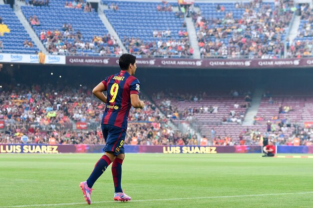 BARCELONA, SPAIN - AUGUST 18:  Luis Suarez of FC Barcelona walks onto the pitch during the official presentation of the FC Barcelona team prior to the Joan Gamper Trophy match between FC Barcelona and Club Leon at Camp Nou on August 18, 2014 in Barcelona, Spain.  (Photo by David Ramos/Getty Images)