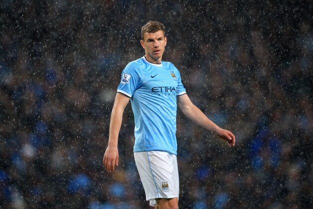 MANCHESTER, ENGLAND - MAY 07:  Edin Dzeko of Manchester City looks on in the rain during the Barclays Premier League match between Manchester City and Aston Villa at Etihad Stadium on May 7, 2014 in Manchester, England.  (Photo by Michael Regan/Getty Images)