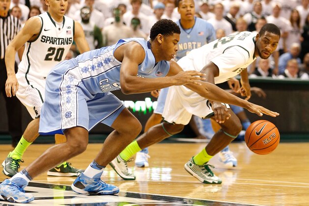 EAST LANSING, MI - DECEMBER 04:  Isaiah Hicks #22 of the North Carolina Tar Heels tries to control the ball next to Branden Dawson #22 of the Michigan State Spartans during the first half at the Jack T. Breslin Student Events Center on December 4, 2013 in East Lansing, Michigan. (Photo by Gregory Shamus/Getty Images)