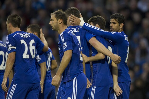 Chelsea's Diego Costa, right, celebrates with teammates after scoring against Burnley during their English Premier League soccer match at Turf Moor Stadium, Burnley, England, Monday Aug. 18, 2014. (AP Photo/Jon Super)