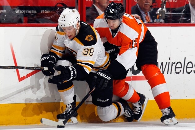 PHILADELPHIA, PA - MARCH 30: Jordan Caron #38 of the Boston Bruins ducks under a check from Simon Gagne #12 of the Philadelphia Flyers during the first period at the Wells Fargo Center on March 30, 2013 in Philadelphia, Pennsylvania.  (Photo by Bruce Bennett/Getty Images)