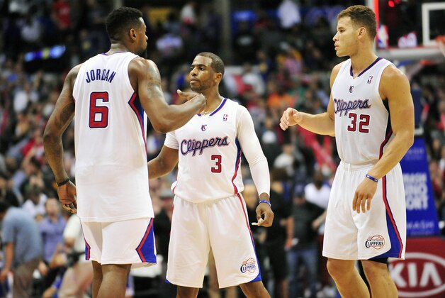 March 12, 2014; Los Angeles, CA, USA; Los Angeles Clippers center DeAndre Jordan (6), guard Chris Paul (3) and forward Blake Griffin (32) celebrate the 111-98 victory against the Golden State Warriors following the second half at Staples Center. Mandatory Credit: Gary A. Vasquez-USA TODAY Sports