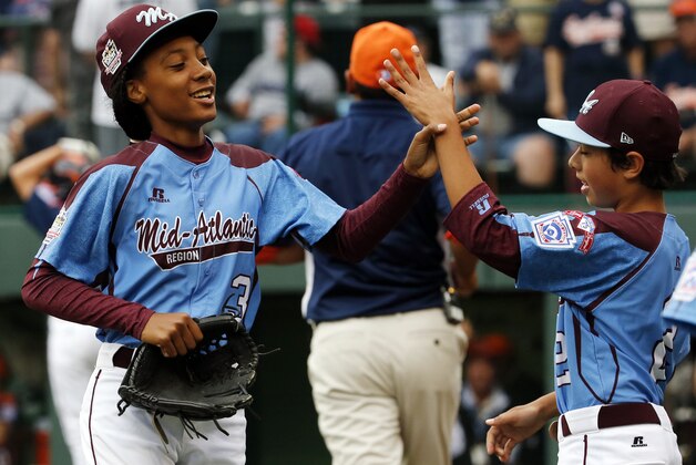 Pennsylvania pitcher Mo'ne Davis, left, celebrates with teammate Jack Rice (2) after getting the final out of a 4-0 shutout against Tennessee during a baseball game in United States pool play at the Little League World Series tournament in South Williamsport, Pa., Friday, Aug. 15, 2014. (AP Photo/Gene J. Puskar)