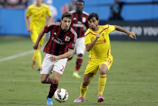 AC Milan's Mattia De Sciglio (2) looks to advance the ball against Liverpool's Suso (30) during a Guinness International Champions Cup soccer match in Charlotte, N.C., Saturday, Aug. 2, 2014. Liverpool won 2-0. (AP Photo/Bob Leverone)