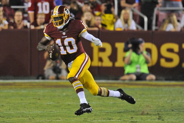 Washington Redskins quarterback Robert Griffin III (10) runs with the ball during the first half of an NFL preseason football game against the Cleveland Browns Monday, Aug. 18, 2014, in Landover, Md. (AP Photo/Richard Lipski)