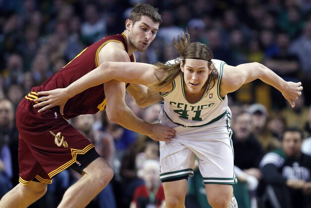 Boston Celtics' Kelly Olynyk (41) and Cleveland Cavaliers' Tyler Zeller (40) chase a loose ball in the third quarter of an NBA basketball game in Boston, Saturday, Dec. 28, 2013. The Celtics won 103-100. (AP Photo/Michael Dwyer)
