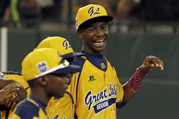 Chicago's Pierce Jones, right, walks off the field with teammates after a 8-7 win over  Cumberland in an elimination baseball game at the Little League World Series tournament in South Williamsport, Pa., Monday, Aug. 18, 2014. (AP Photo/Gene J. Puskar)