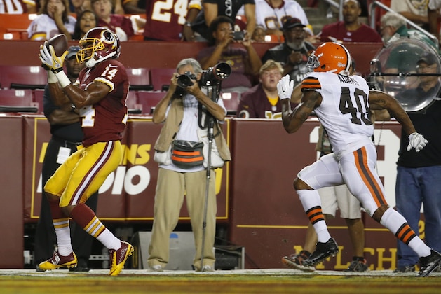 Washington Redskins wide receiver Ryan Grant (14) catches a touchdown pass in front of Cleveland Browns defensive back Royce Adams (40) during the second half of an NFL preseason football game Monday, Aug. 18, 2014, in Landover, Md. (AP Photo/Evan Vucci)
