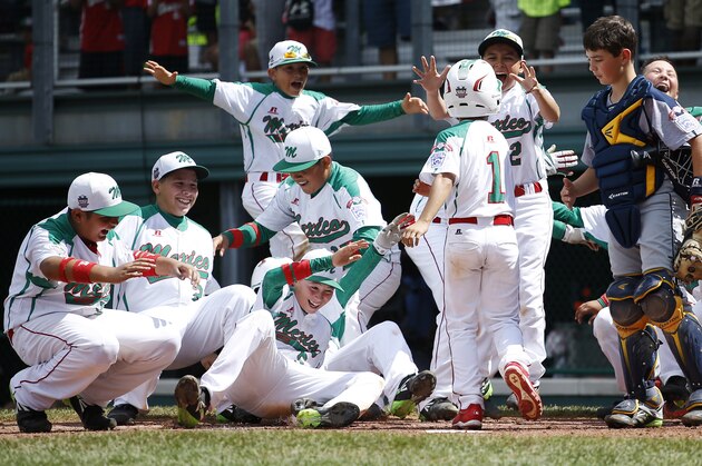 Mexico’s Ruy Martinez (1) celebrates with his teammates at home plate after hitting a home run during the fifth inning of an International elimination baseball game against Australia at the Little League World Series, Monday, Aug. 18, 2014, in South Williamsport, Pa. Mexico won 6-2. (AP Photo/Matt Slocum)
