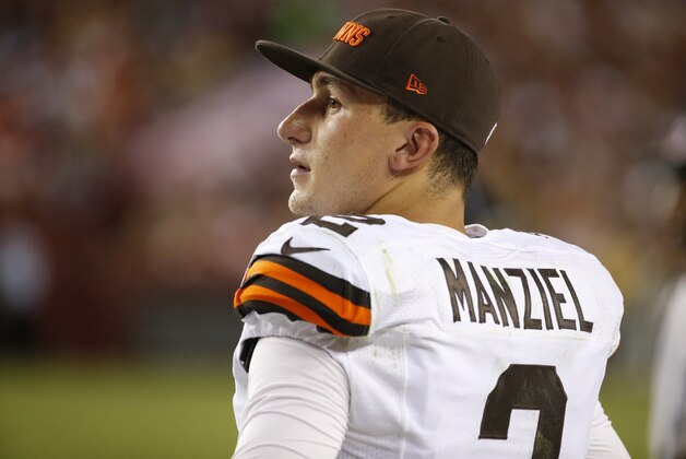 Cleveland Browns quarterback Johnny Manziel (2) watches from the sidelines during the first half of an NFL preseason football game against the Washington Redskins Monday, Aug. 18, 2014, in Landover, Md. (AP Photo/Evan Vucci)