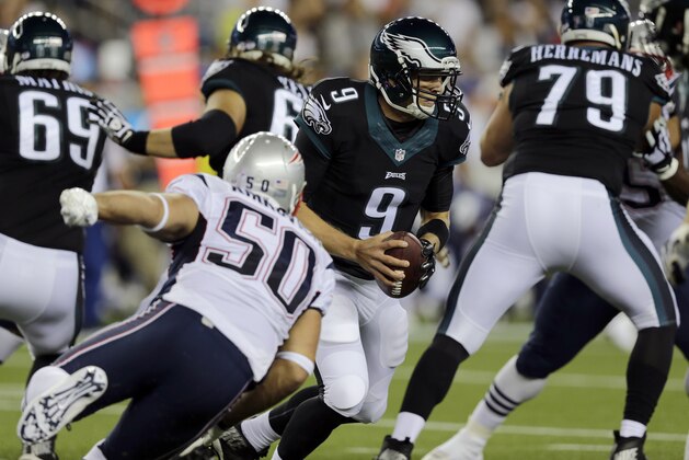 New England Patriots defensive end Rob Ninkovich (50) chases Philadelphia Eagles quarterback Nick Foles (9)in the first half of an NFL preseason football game Friday, Aug. 15, 2014, in Foxborough, Mass. (AP Photo/Charles Krupa)
