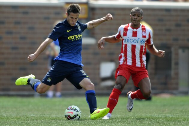 MINNEAPOLIS, MN - AUGUST 2: Bruno Zuculini #36 of Manchester City controls the ball Mathieu Dossevi #77 of Olympiacos of the International Champions Cup match in the second half on August 2, 2014 at TCF Bank Stadium in Minneapolis, Minnesota. The Olympiacos defeated the Manchester City in a penalty shootout. (Photo by Hannah Foslien/Getty Images)