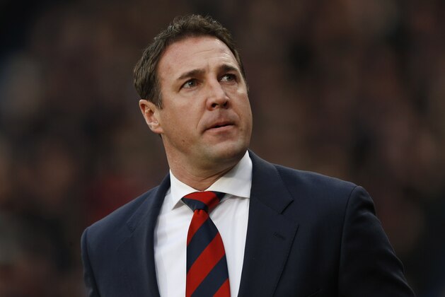 Cardiff City's manager Malky Mackay arrives at the dugout before the start of their English Premier League soccer match against Crystal Palace at Selhurst Park, London, Saturday, Dec. 7, 2013. (AP Photo/Sang Tan)