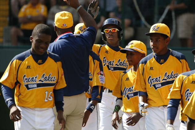 Chicago's Pierce Jones, center, celebrates with teammates after hitting a two-run home run off Lynnwood, Washington pitcher Logan Kruse during the third inning of a Little League baseball game in United States pool play at the Little League World Series tournament in South Williamsport, Pa., Thursday, Aug. 14, 2014. Pierce hit three home runs and a triple to lead Chicago to a 12-2 win. (AP Photo/Gene J. Puskar)
