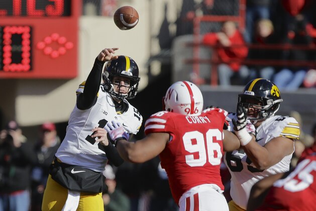 Iowa quarterback Jake Rudock (15)  throws under pressure from Nebraska defensive tackle Aaron Curry (96) in the first half of an NCAA college football game in Lincoln, Neb., Friday, Nov. 29, 2013. (AP Photo/Nati Harnik)