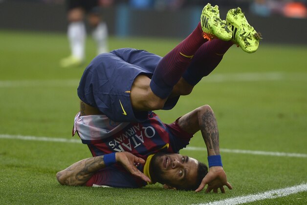 FC Barcelona's Dani Alves, from Brazil, falls down during a Spanish La Liga soccer match against Valencia at the Camp Nou stadium in Barcelona, Spain, Saturday, Feb. 1, 2014. (AP Photo/Manu Fernandez)