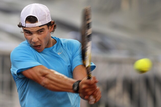 Spain's Rafael Nadal returns the ball during a tennis training session at the La Cartuja stadium, in Seville, Spain, Tuesday, Nov. 29, 2011. Spain will play Argentina in the Davis Cup final, which begins Friday. (AP Photo/Miguel Angel Morenatti)