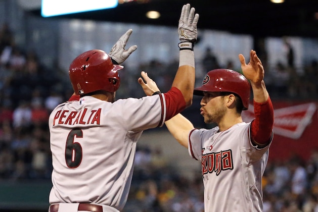 Arizona Diamondbacks' David Peralta (6) celebrates with teammate Ender Inciarte who was on base for his two-run home run off Pittsburgh Pirates starting pitcher Vance Worley during the sixth inning of a baseball game in Pittsburgh Thursday, July 3, 2014. (AP Photo/Gene J. Puskar)
