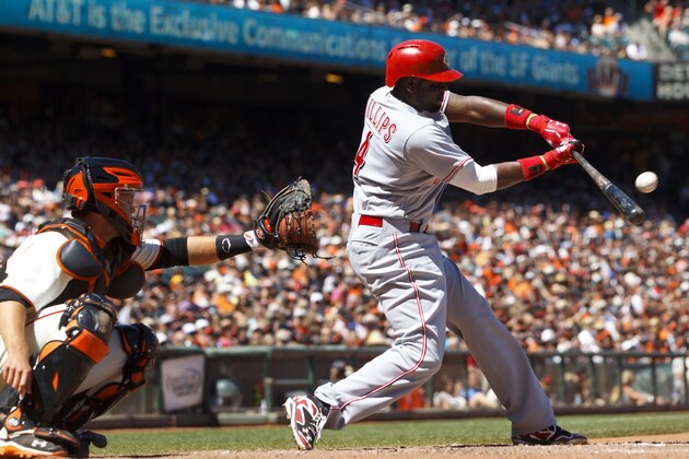 SAN FRANCISCO, CA - JUNE 29: Brandon Phillips #4 of the Cincinnati Reds hits an RBI sacrifice fly against the San Francisco Giants during the ninth inning at AT&T Park on June 29, 2014 in San Francisco, California. The Cincinnati Reds defeated the San Francisco Giants 4-0. (Photo by Jason O. Watson/Getty Images)
