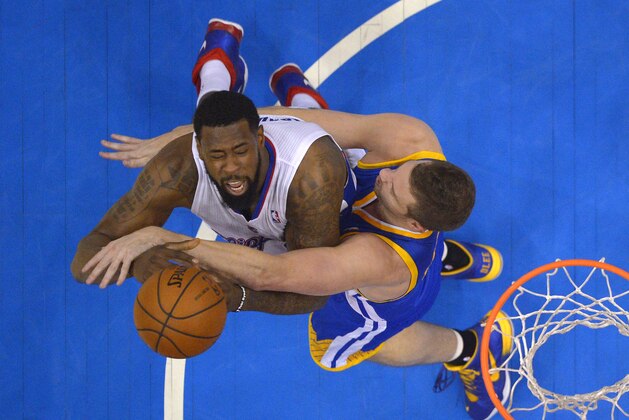 Los Angeles Clippers center DeAndre Jordan, left, puts up a shot as Golden State Warriors forward David Lee defends during the first half in Game 7 of an opening-round NBA basketball playoff series, Sunday, May 4, 2014, in Los Angeles. The Clippers won 126-121. (AP Photo/Mark J. Terrill)