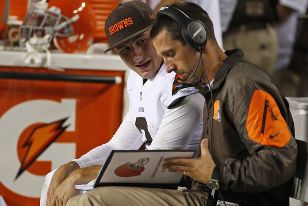 Cleveland Browns quarterback Johnny Manziel (2) talks with  offensive coordinator Kyle Shanahan during the second half of an NFL preseason football game against the Washington Redskins Monday, Aug. 18, 2014, in Landover, Md. (AP Photo/Evan Vucci)
