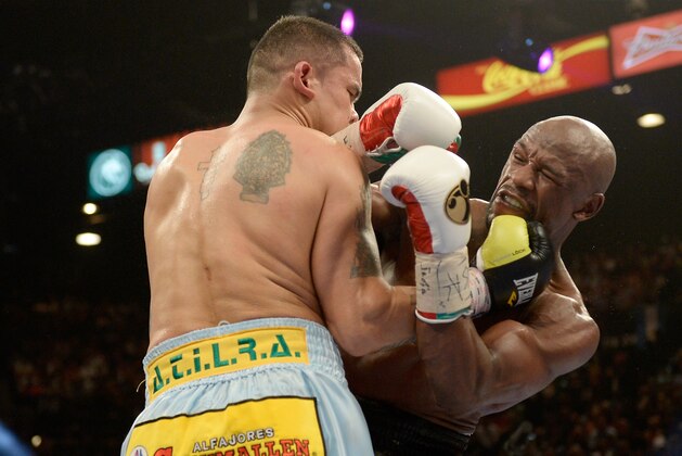 LAS VEGAS, NV - MAY 03:  (L-R) Marcos Maidana and  Floyd Mayweather Jr. exchange blows during their WBC/WBA welterweight unification fight at the MGM Grand Garden Arena on May 3, 2014 in Las Vegas, Nevada. Mayweather took Maidana's title with a majority-decision victory.  (Photo by Harry How/Getty Images)