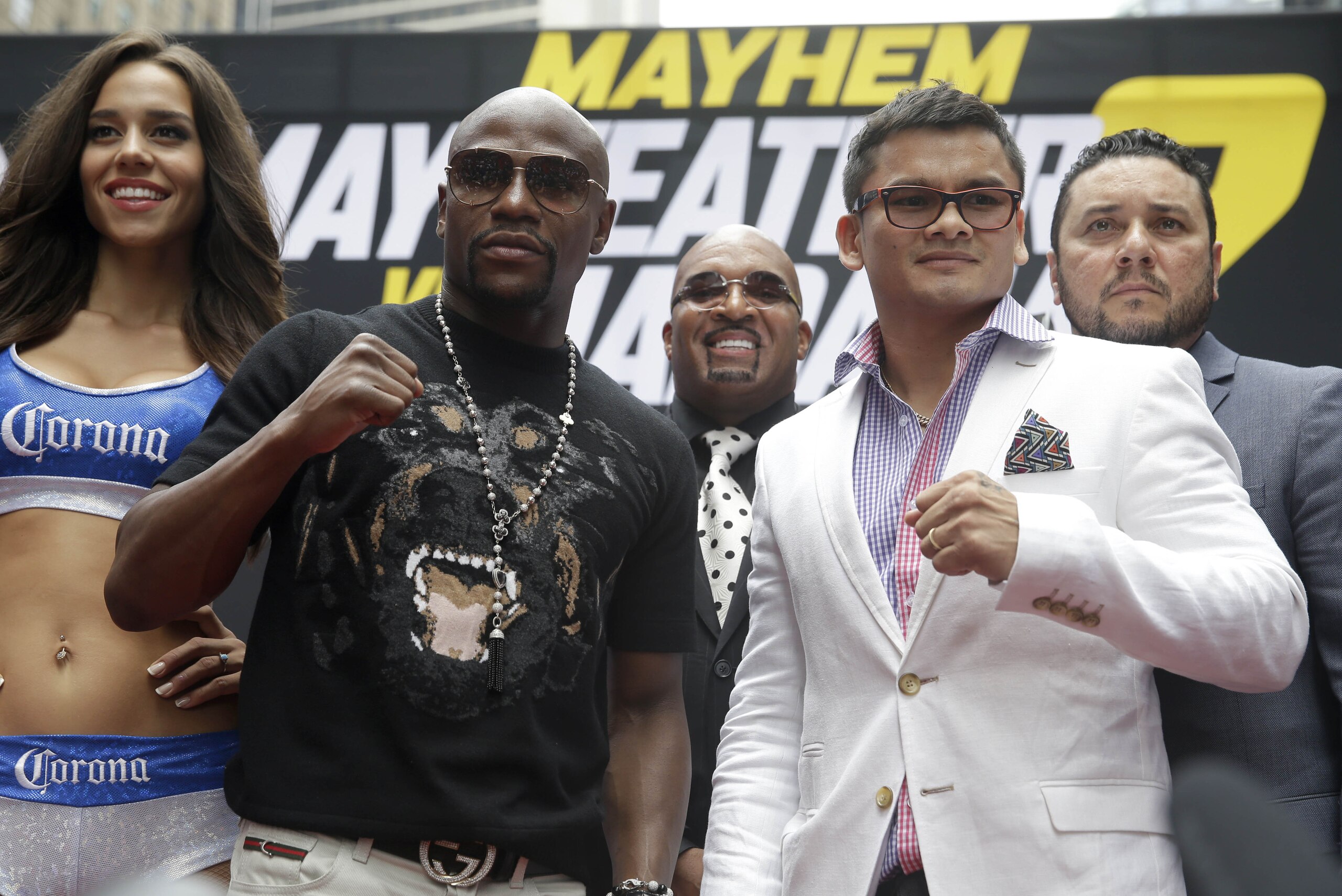 Floyd Mayweather, second from left, poses for a picture with Marcos Maidana, second from right, during the outdoor portion of a news conference in Times Square, New York, Monday, July 14, 2014. Mayweather will fight Maidana for the second time in Las Vegas, Nevada on Sept. 13, 2014. (AP Photo/Seth Wenig)