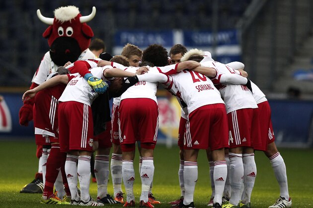 SALZBURG, AUSTRIA - MARCH 23: Players of Salzburg and their mascot stay together before the tipp3 Bundesliga match between Red Bull Salzburg and SC Wiener Neustadt at Red Bull Arena on March 23, 2014 in Salzburg, Austria.  (Photo by Simon Hausberger/Getty Images)