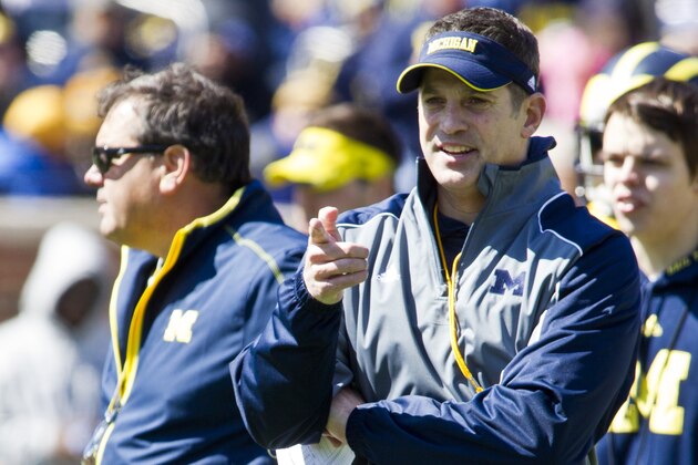 Michigan offensive coordinator Doug Nussmeier, front, stands next to head coach Brady Hoke, left, during the football team's annual spring game, Saturday, April 5, 2014, in Ann Arbor, Mich. (AP Photo/Tony Ding)