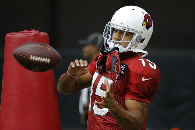 Arizona Cardinals receiver Michael Floyd makes a catch during an NFL football training camp, Tuesday, July 29, 2014, in Glendale, Ariz. (AP Photo/Matt York)