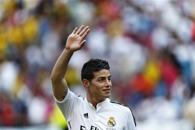 FILE - In this July 22, 2014 file photo, new Real Madrid player James Rodriguez, from Colombia, waves during his official presentation at the Santiago Bernabeu stadium in Madrid, Spain. The versatile playmaker, who landed the $108-million move from Monaco after scoring a World Cup-leading six goals for Colombia, is in the starting lineup for the European champions against Sevilla at Cardiff City’s stadium.  (AP Photo/Daniel Ochoa de Olza, File)