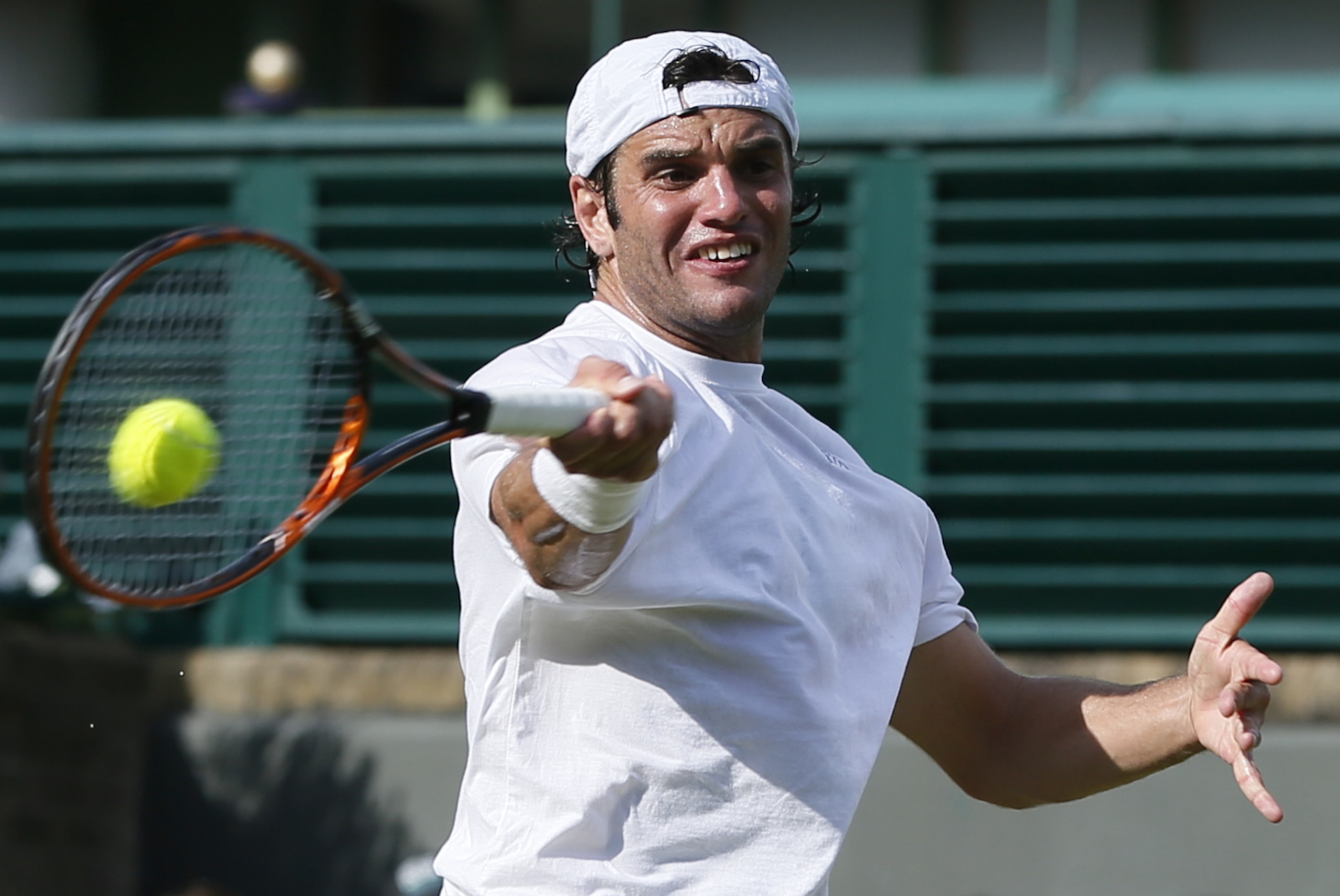 Malek Jaziri of Tunisia returns against Gael Monfils of France during their first round match at the All England Lawn Tennis Championships in Wimbledon, London, Tuesday, June 24, 2014. (AP Photo/Alastair Grant)