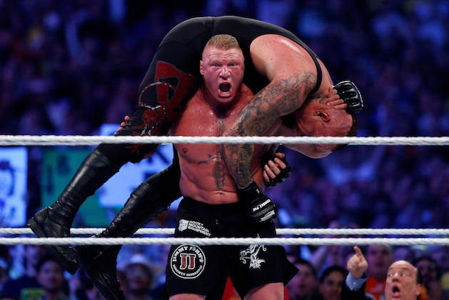 The Undertake, top, and Brock Lesnar, bottom, compete during Wrestlemania XXX at the Mercedes-Benz Super Dome in New Orleans on Sunday, April 6, 2014. (Jonathan Bachman/AP Images for WWE)