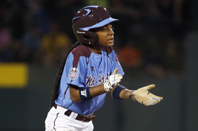 Philadelphia's Mo'ne Davis celebrates as she stands on second during the first inning of a baseball game against Pearland in United States pool play at the Little League World Series tournament in South Williamsport, Pa., Sunday, Aug. 17, 2014. (AP Photo/Gene J. Puskar
