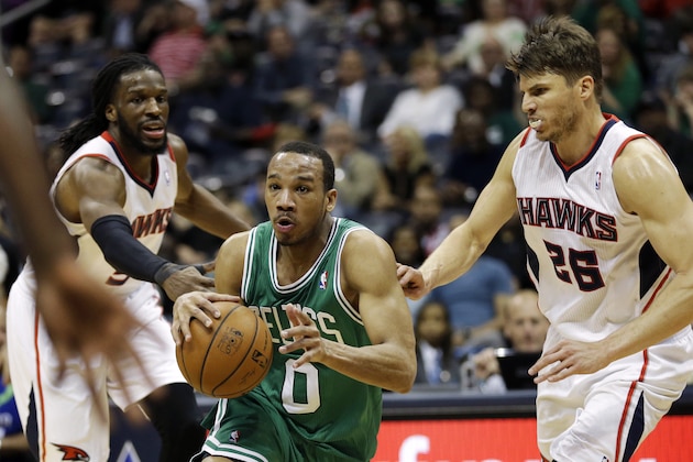 Boston Celtics' Avery Bradley, center, drives to the hoop against Atlanta Hawks' DeMarre Carroll, left, and Kyle Korver, right, in the fourth quarter of an NBA basketball game, Wednesday, April 9, 2014, in Atlanta. The Hawks won 105-97. (AP Photo/David Goldman)