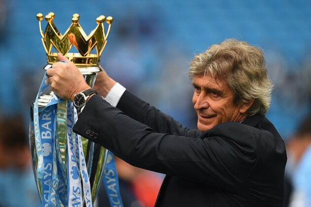 MANCHESTER, ENGLAND - MAY 11:  The Manchester City Manager Manuel Pellegrini poses with the Premier League trophy at the end of the Barclays Premier League match between Manchester City and West Ham United at the Etihad Stadium on May 11, 2014 in Manchester, England.  (Photo by Shaun Botterill/Getty Images)