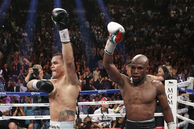 Floyd Mayweather Jr., right, and Marcos Maidana, from Argentina, both react at the end of their WBC-WBA welterweight title boxing fight Saturday, May 3, 2014, in Las Vegas. Mayweather won the bout by majority decision. (AP Photo/Eric Jamison)