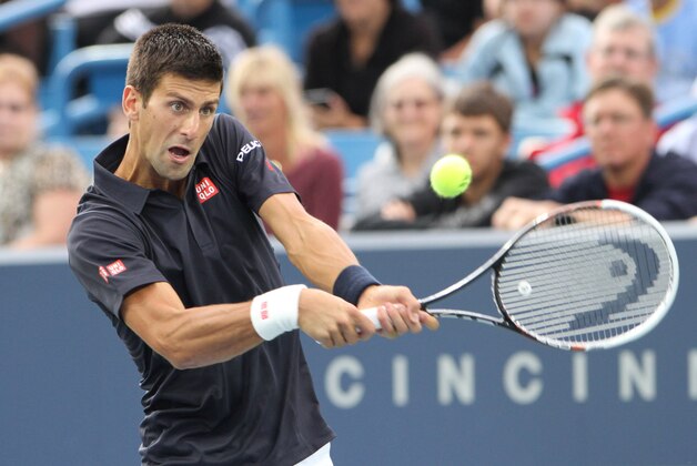 Aug 12, 2014; Cincinnati, OH, USA; Novak Djokovic returns the serve of Gilles Simon on day two of the Western and Southern Open tennis tournament at Linder Family Tennis Center. Mandatory Credit: Mark Zerof-USA TODAY Sports