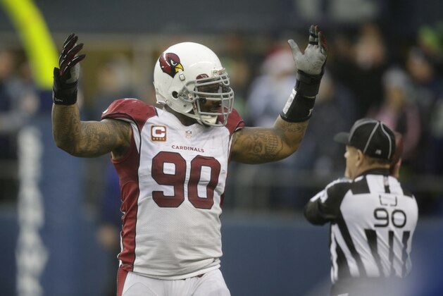 Arizona Cardinals defensive end Darnell Dockett (90) reacts after a play in the second half of an NFL football game against the Seattle Seahawks, Sunday, Dec. 22, 2013, in Seattle. (AP Photo/Stephen Brashear)