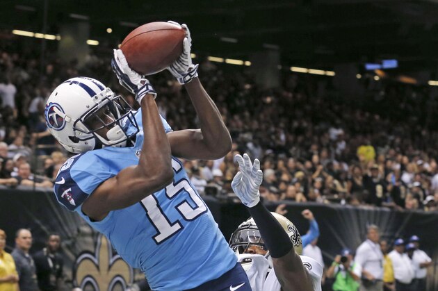 Tennessee Titans wide receiver Justin Hunter (15) pulls in a touchdown reception over New Orleans Saints cornerback Corey White (24) in the first half of a NFL preseason football game in New Orleans, Friday, Aug. 15, 2014. (AP Photo/Bill Haber)