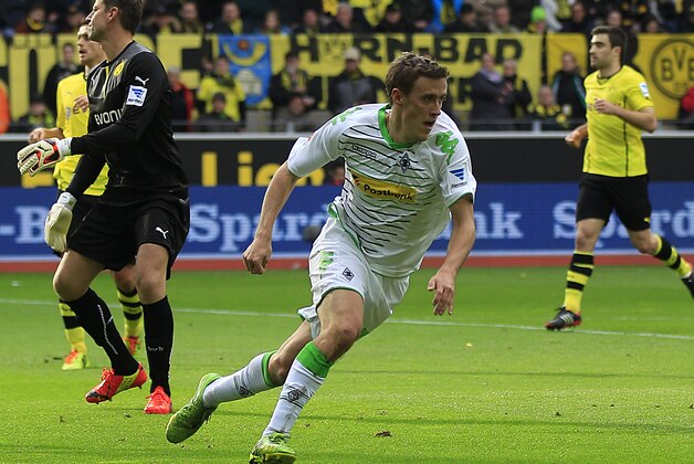 Moenchengladbach's Max Kruse, center, celebrates after scoring during the German first division Bundesliga soccer match between BvB Borussia Dortmund  and VfL Borussia Moenchengladbach in Dortmund, Germany, Saturday, March 15, 2014. (AP Photo/Frank Augstein)