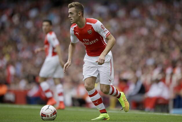 Arsenal's Calum Chambers controls the ball as he makes his debut during the Emirates Cup soccer match between Arsenal and Benfica at Arsenal's Emirates Stadium in London, Saturday, Aug. 2, 2014.  (AP Photo/Matt Dunham)