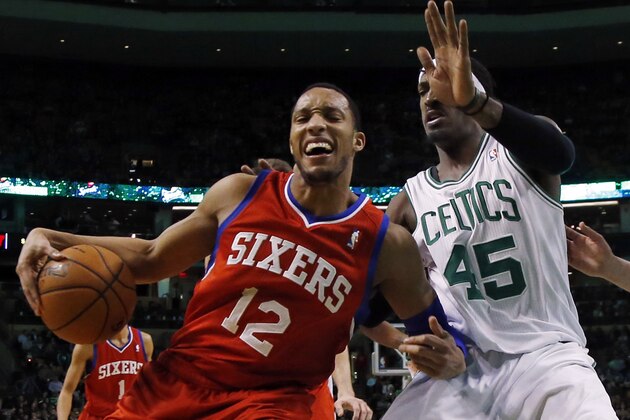 Philadelphia 76ers forward Evan Turner (12) makes a move against Boston Celtics forward Gerald Wallace (45) during the first half of an NBA basketball game in Boston, Wednesday, Jan. 29, 2014. (AP Photo/Elise Amendola)