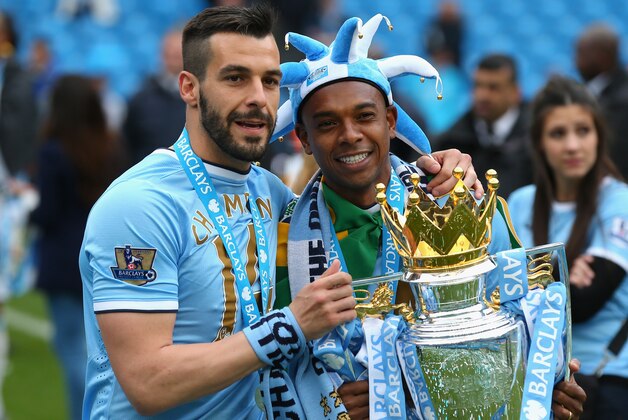 MANCHESTER, ENGLAND - MAY 11:  Alvaro Negredo and Fernandinho (R) of Manchester City pose with the trophy at the end of the Barclays Premier League match between Manchester City and West Ham United at the Etihad Stadium on May 11, 2014 in Manchester, England.  (Photo by Alex Livesey/Getty Images)