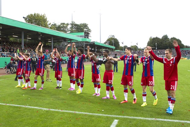 Players of Bayern Munich celebrate after the German soccer cup first round match between SC Preussen Muenster and FC Bayern Munich in Muenster, Germany, Sunday, Aug. 17, 2014. Munich won  by 4-1. (AP Photo/Joerg Sarbach)